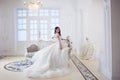 Portrait of beautiful laughing bride. Wedding dress with open back. Luxurious light interior Royalty Free Stock Photo