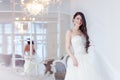 Portrait of beautiful laughing bride. Wedding dress with open back. Luxurious light interior Royalty Free Stock Photo