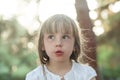 Portrait of a beautiful liitle girl close-up outdoors