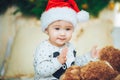 Portrait of beautiful little baby boy celebrates Christmas. New Year's holidays. Adorable funny child in Santa red hat Royalty Free Stock Photo
