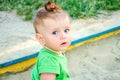 Portrait of a beautiful little baby girl child plays bucket, rake and shovel in the sandbox sand Royalty Free Stock Photo