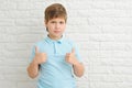 Portrait of beautiful little boy giving you thumbs up over white background Royalty Free Stock Photo