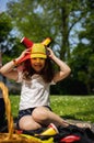 Portrait of a girl in a Belgian flag hat with horns on a picnic. Royalty Free Stock Photo