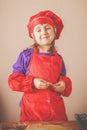 Portrait of beautiful little chef girl preparing homemade pizza Royalty Free Stock Photo