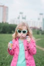 Portrait of a beautiful little five year old girl in a city park Royalty Free Stock Photo