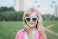 Portrait of a beautiful little five year old girl in a city park Royalty Free Stock Photo