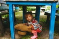 Child with a big straw hat in hands in rural style. Rural portrait Royalty Free Stock Photo