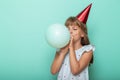 Little girl blowing a balloon and celebrating birthday Royalty Free Stock Photo