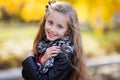 Portrait of a beautiful little girl. A child walks in a beautiful autumn park