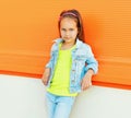 Portrait of beautiful little girl child wearing a sunglasses, jeans jacket on city street Royalty Free Stock Photo