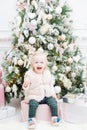 Portrait beautiful little girl Christmas tree in the background. light bulbs garlands Royalty Free Stock Photo