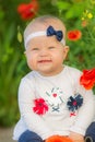 Portrait of a beautiful little girl having fun in field of red poppy flowers in spring. Royalty Free Stock Photo