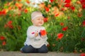 Portrait of a beautiful little girl having fun in field of red poppy flowers in spring. Royalty Free Stock Photo