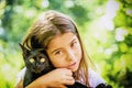 Portrait of a beautiful little girl holding a black cat Royalty Free Stock Photo