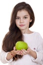 Portrait of a beautiful little girl holding a green apple Royalty Free Stock Photo