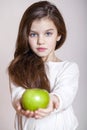 Portrait of a beautiful little girl holding a green apple Royalty Free Stock Photo