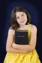 Portrait of beautiful little girl holding Holy Bible Royalty Free Stock Photo