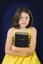 Portrait of beautiful little girl holding Holy Bible Royalty Free Stock Photo