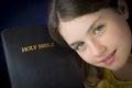 Portrait of beautiful little girl holding Holy Bible Royalty Free Stock Photo