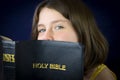 Portrait of beautiful little girl holding Holy Bible