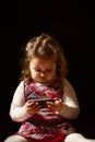 Portrait of a beautiful little girl holding mobile phone Royalty Free Stock Photo