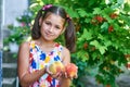 Portrait of a beautiful little girl with peaches