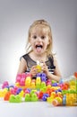 Portrait of beautiful little girl playing with plastic toy cubes Royalty Free Stock Photo