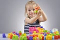 Portrait of beautiful little girl playing with plastic toy cubes Royalty Free Stock Photo