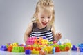 Portrait of beautiful little girl playing with plastic toy cubes Royalty Free Stock Photo