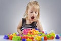 Portrait of beautiful little girl playing with plastic toy cubes Royalty Free Stock Photo