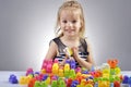 Portrait of beautiful little girl playing with plastic toy cubes Royalty Free Stock Photo