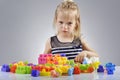 Portrait of beautiful little girl playing with plastic toy cubes Royalty Free Stock Photo