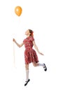 Portrait of beautiful little girl in retro skirt and shirt posing with air balloon isolated over white studio background Royalty Free Stock Photo