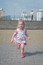 Portrait of beautiful little girl running towards camera with smile Royalty Free Stock Photo