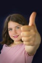 Portrait of beautiful little girl showing ok sign