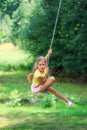 Portrait of Beautiful little girl Is swinging and playing at summer park. Soft focused