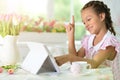 Portrait of beautiful little girl with tablet pc has an idea Royalty Free Stock Photo