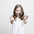 Portrait of a beautiful little girl in a white dress and veil on