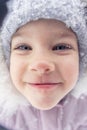 Portrait of a beautiful little girl 4 years old in winter clothes outdoor