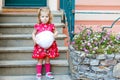 Portrait of beautiful little gorgeus lovely toddler girl in pink summer look clothes, fashion dress, knee socks and hat Royalty Free Stock Photo