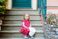 Portrait of beautiful little gorgeus lovely toddler girl in pink summer look clothes, fashion dress, knee socks and hat Royalty Free Stock Photo