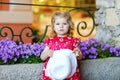 Portrait of beautiful little gorgeus lovely toddler girl in pink summer look clothes, fashion dress, knee socks and hat Royalty Free Stock Photo