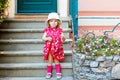 Portrait of beautiful little gorgeus lovely toddler girl in pink summer look clothes, fashion dress, knee socks and hat Royalty Free Stock Photo