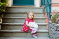 Portrait of beautiful little gorgeus lovely toddler girl in pink summer look clothes, fashion dress, knee socks and hat Royalty Free Stock Photo