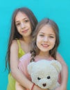 Portrait of beautiful little sisters with Teddy bear