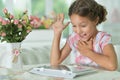 Portrait of beautiful little surprised girl with tablet pc Royalty Free Stock Photo