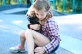Portrait of a beautiful little teenage girl, hugging a small dog Royalty Free Stock Photo