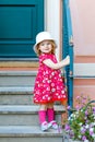 Portrait of beautiful little toddler girl in pink summer look clothes, fashion dress, knee socks and hat. Happy healthy Royalty Free Stock Photo