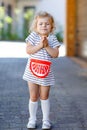 Portrait of beautiful little toddler girl in summer look clothes, fashion dress, knee socks . Happy healthy baby child Royalty Free Stock Photo