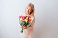 Beautiful mature woman holding tulips. Royalty Free Stock Photo